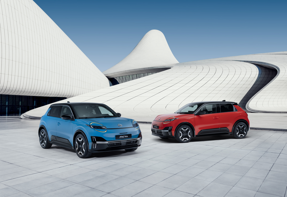 two iconic Micras - gear blue color and red color - parked in front of a blue & white design architectural building in a V shape facing each other Новият електрически Nissan Micra